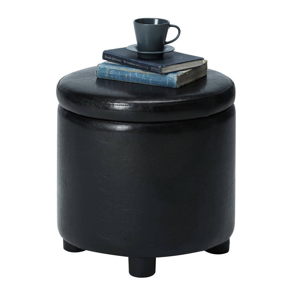 Black faux leather round storage ottoman used as a side table