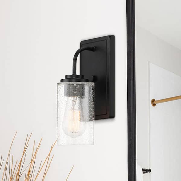 Designers Fountain Logan 4.5 in. 1-Light Matte Black Transitional Wall Sconce with Clear Seedy Glass Shade