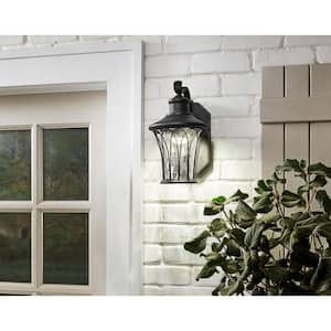 Avia Falls 12.13 in. Black Dusk to Dawn Small LED Outdoor Wall Light Fixture with Clear Water Glass