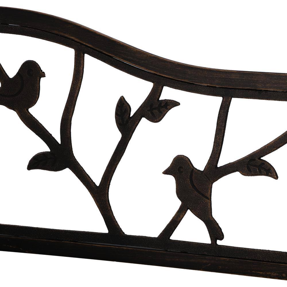 Close-up of the bird pattern cutout on the antique brass garden bench backrest