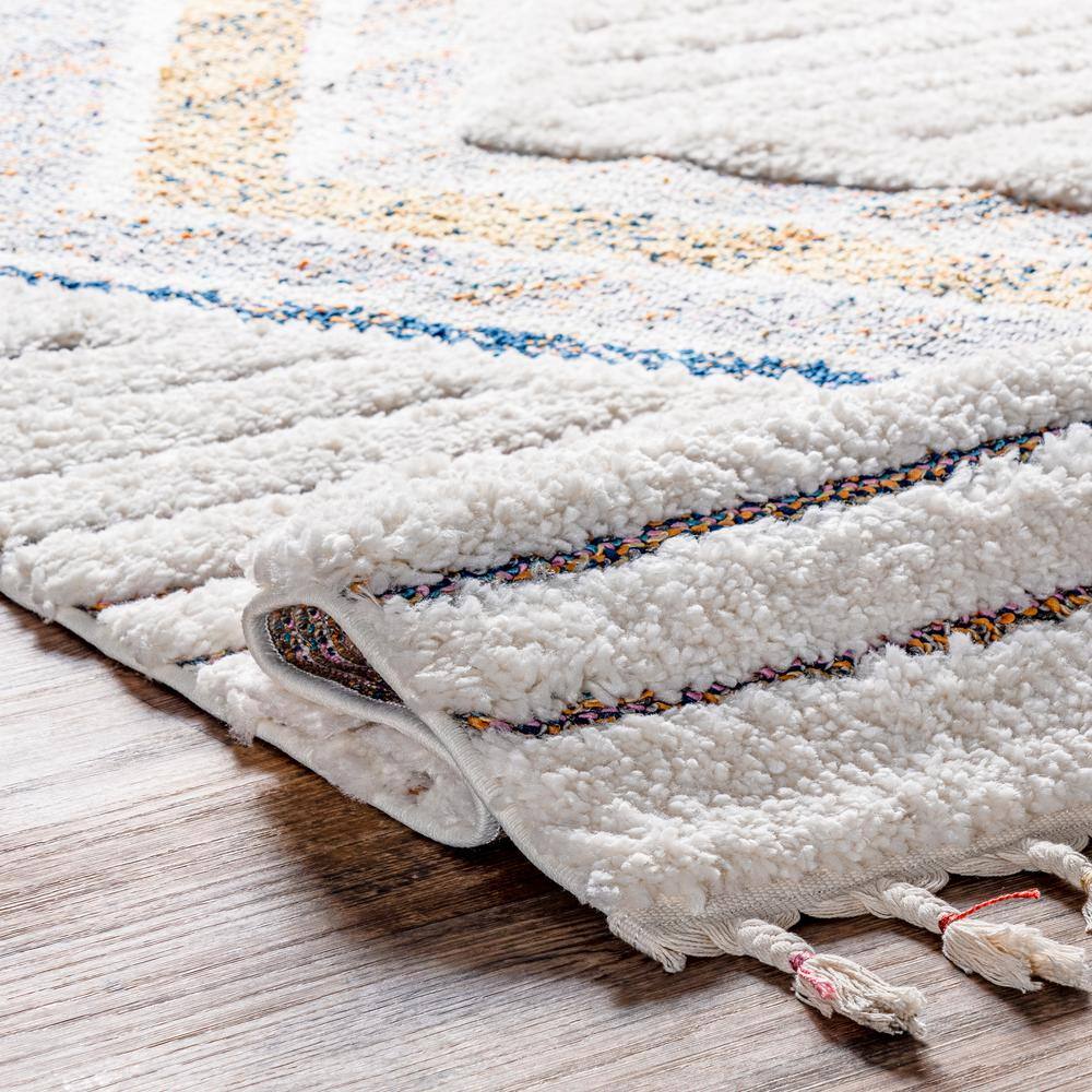 Ivory Geometric Synthetic Rectangular Area Rug with Braided Tassels