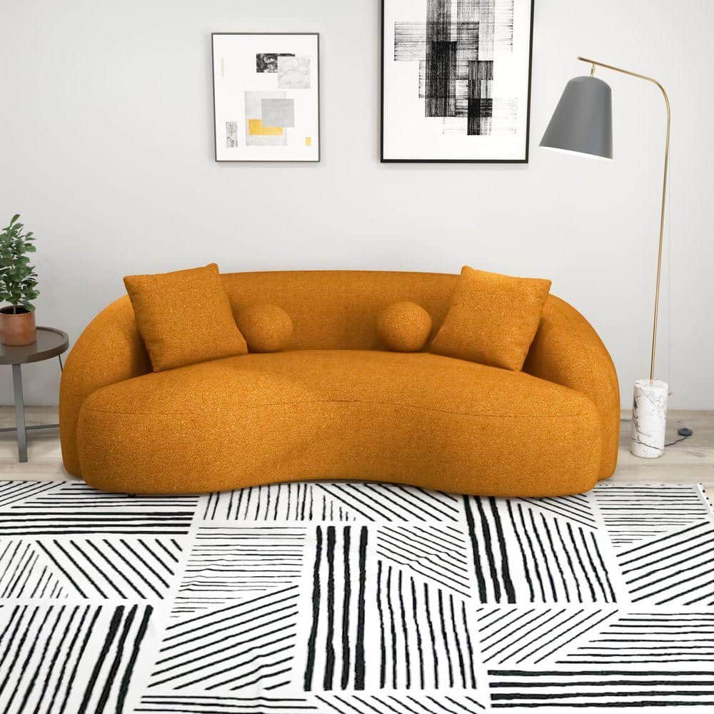 Dark yellow curved 3-seater sofa in a styled room.