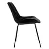 Side profile of a black tufted velvet chair with black metal legs.