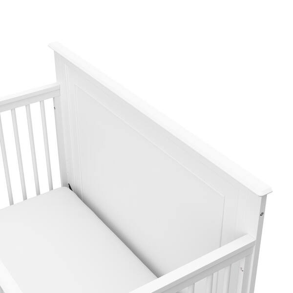 white cot and mattress