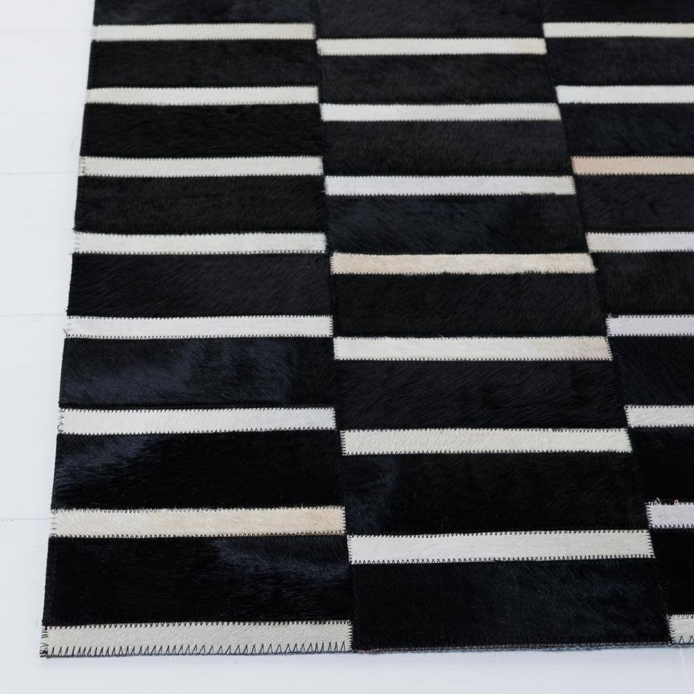 Handmade Black and Beige Geometric Cowhide Area Rug