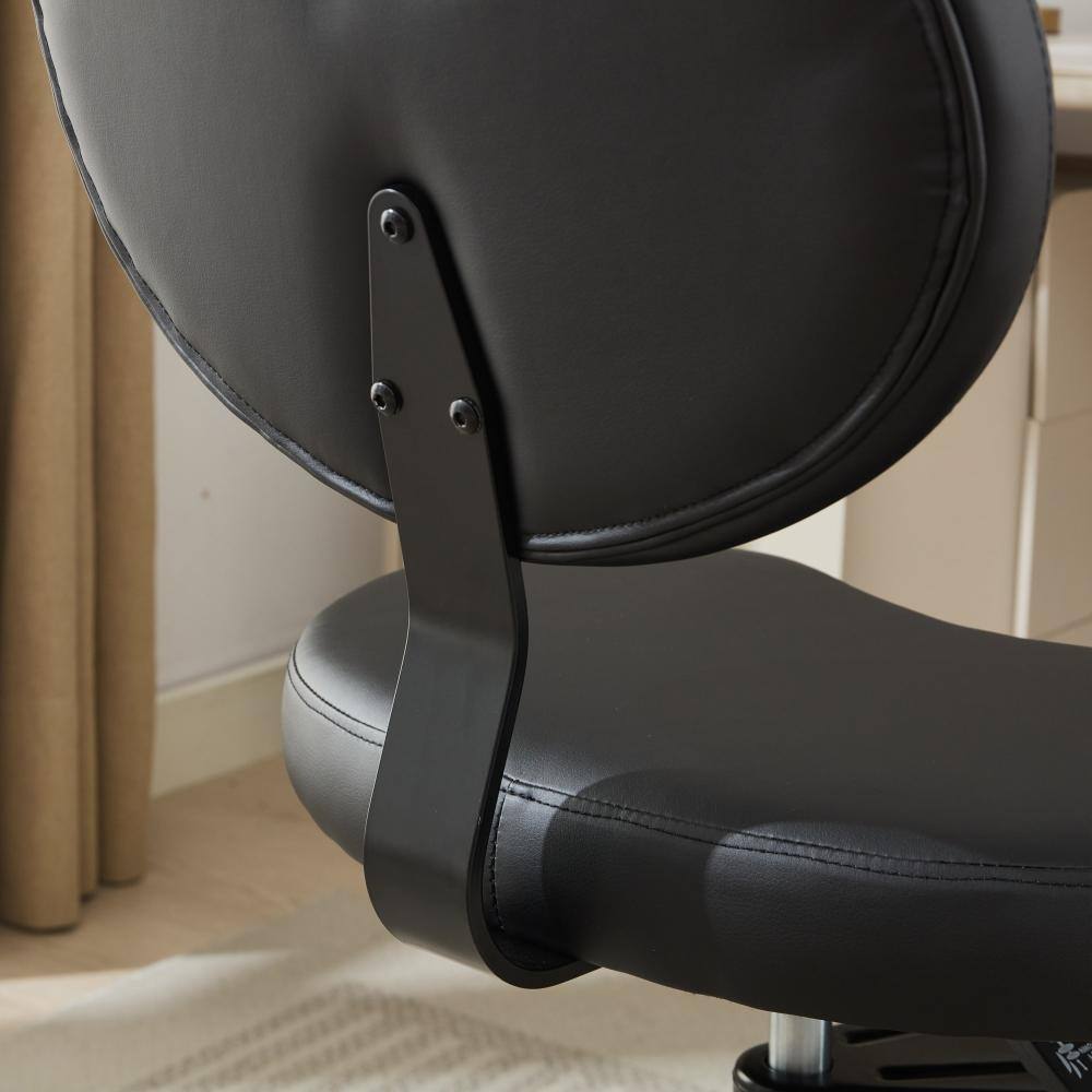 Close-up of the backrest attachment on the black PU leather chair.