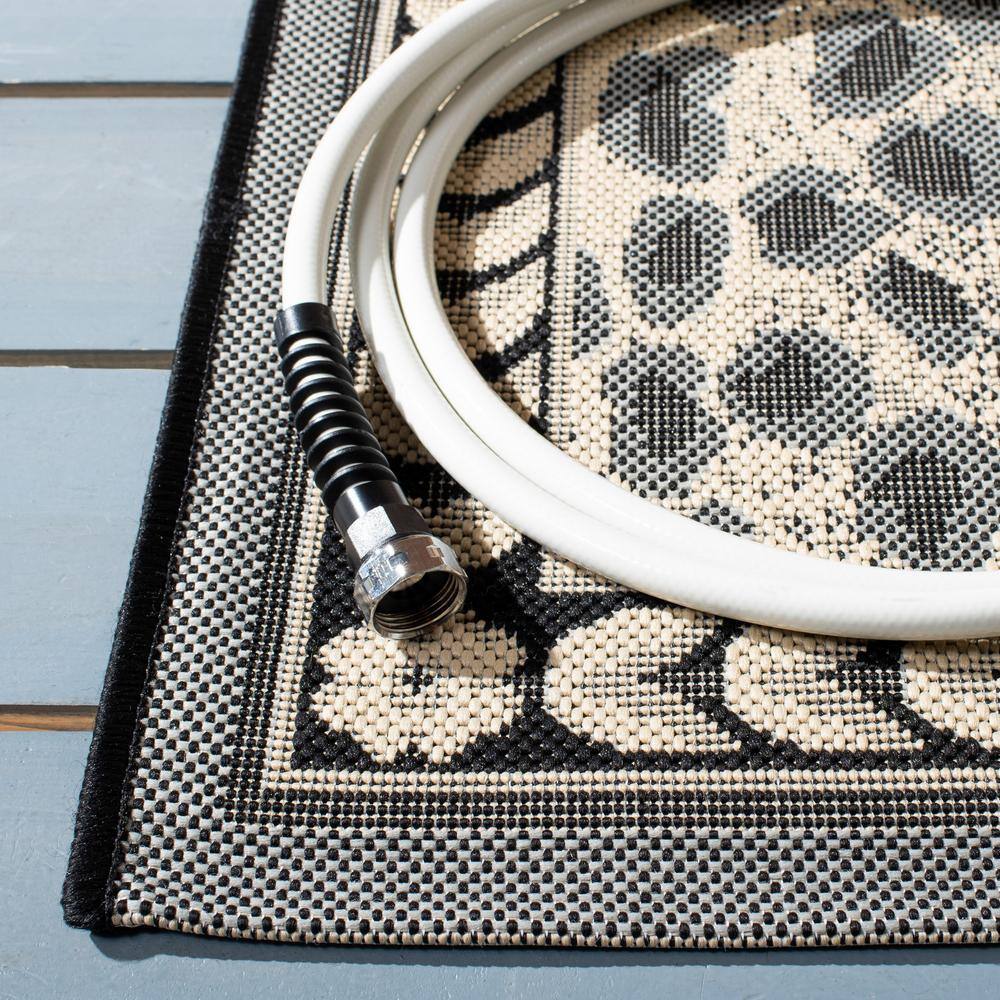 Gray and Black Spotted Synthetic Indoor/Outdoor Area Rug, 9' x 12'