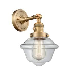 Oxford 1-Light Brushed Brass Wall Sconce with Clear Glass Shade