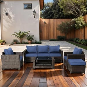 7-Piece Brown Wicker Patio Outdoor Conversation Set with Dark Blue Cushions, Loveseat, Coffee Table, and Storage Box