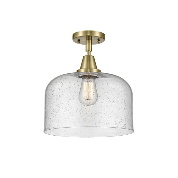 Bell 12 in. 1-Light Antique Brass Industrial Flush Mount with Seeded Glass Shade