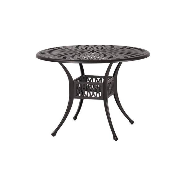 brown outdoor dining table with umbrella hole