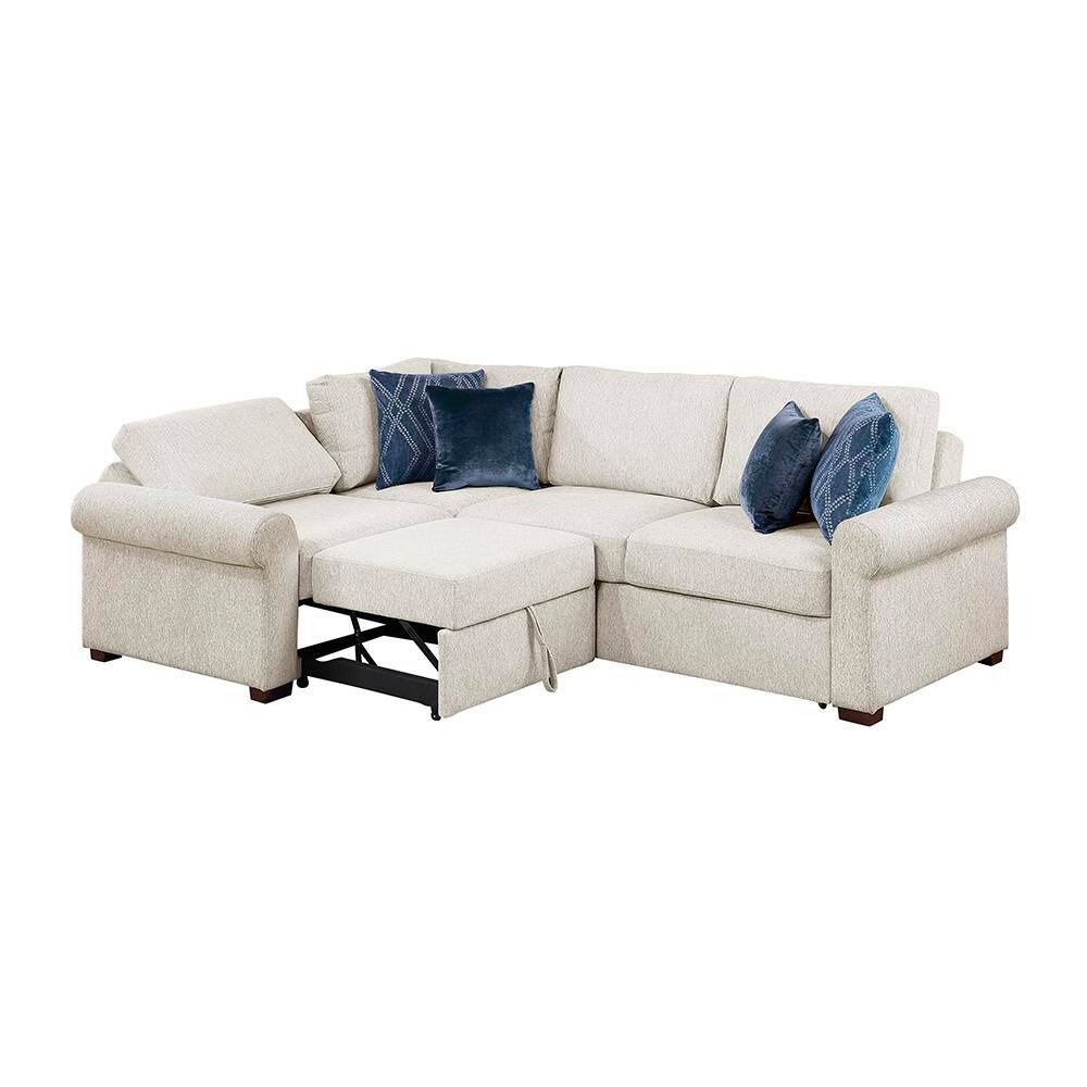 Beige sectional sofa with blue pillows and chaise lounge on a plain background.