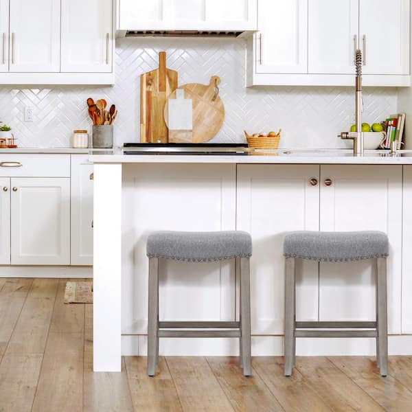 Jameson 24 in Counter Height Antique Gray Wood Backless Nailhead Trim Barstool with Upholstered Gray Linen Saddle Seat