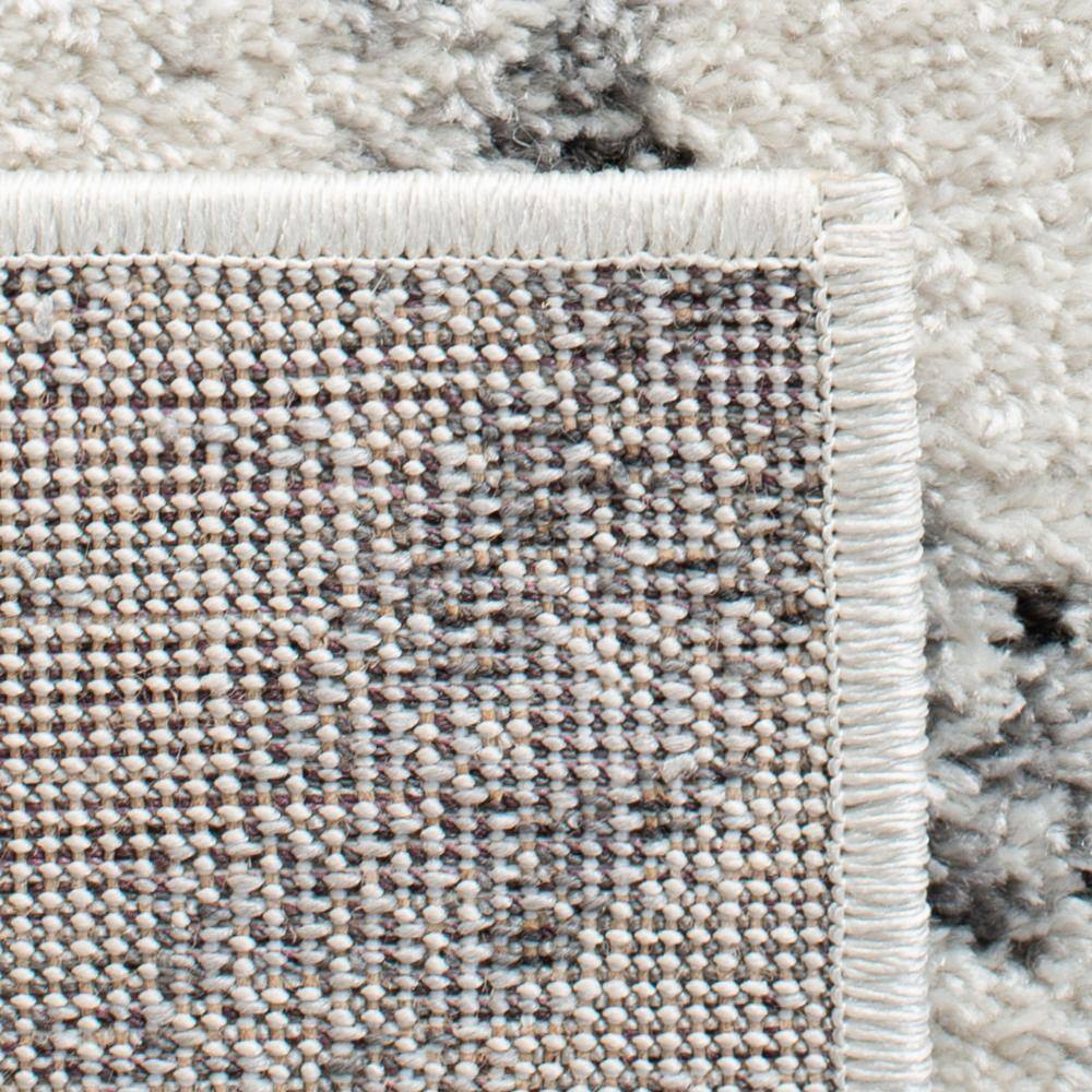 Ivory and Grey Geometric 8' x 10' Synthetic Area Rug