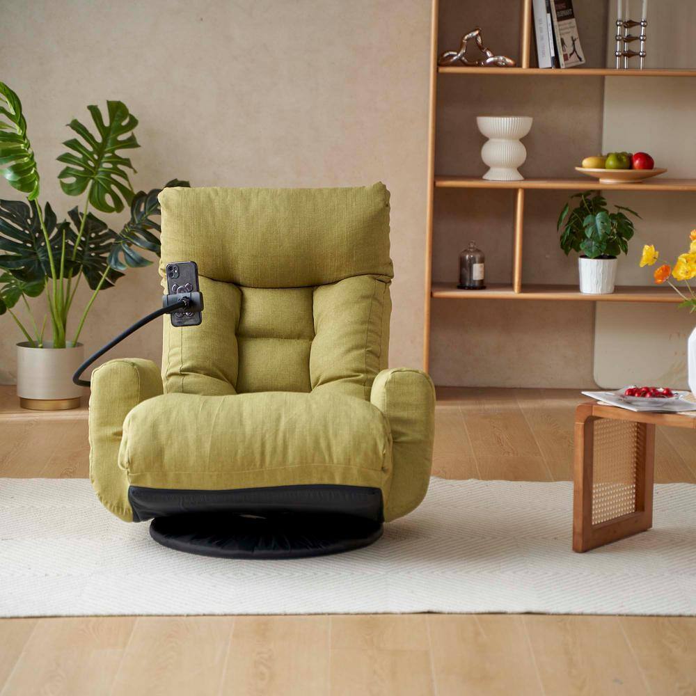 Green lounge chair with a phone holder in a living room setting.