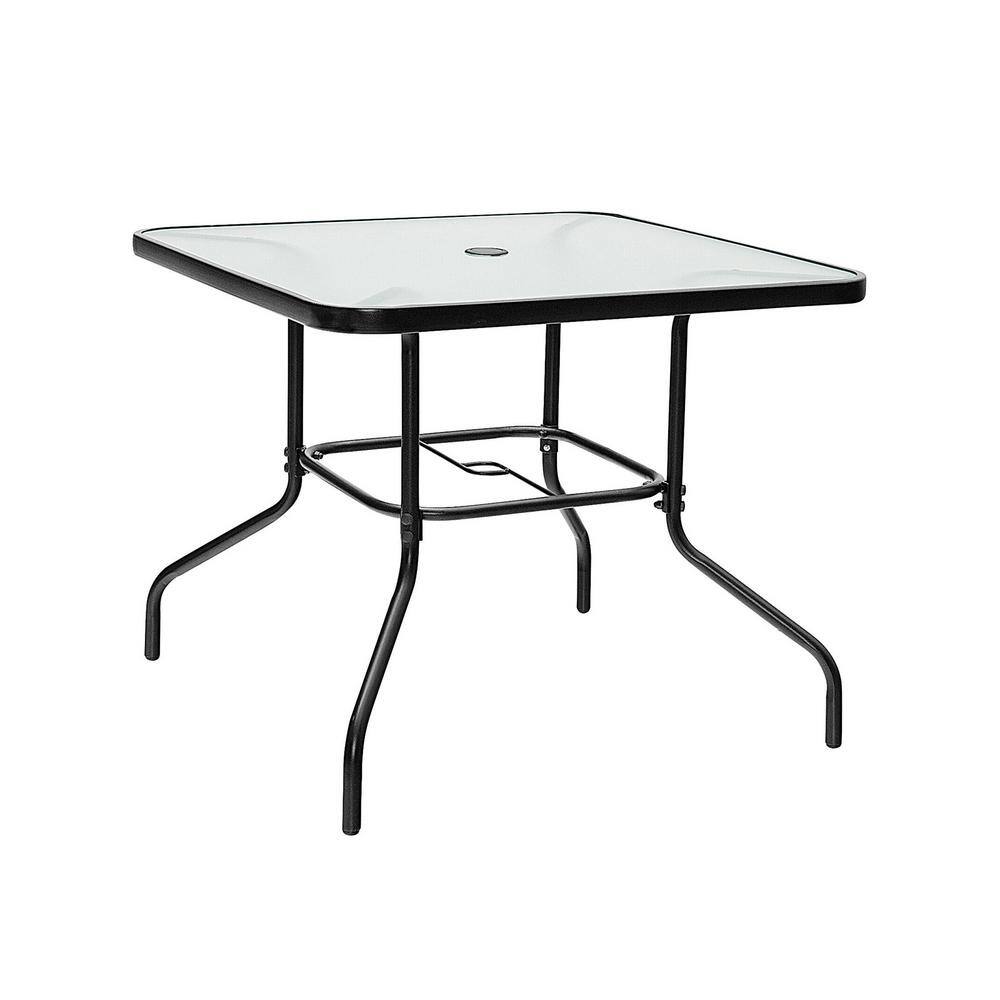 High-angle view of a square black metal outdoor table with a glass top.