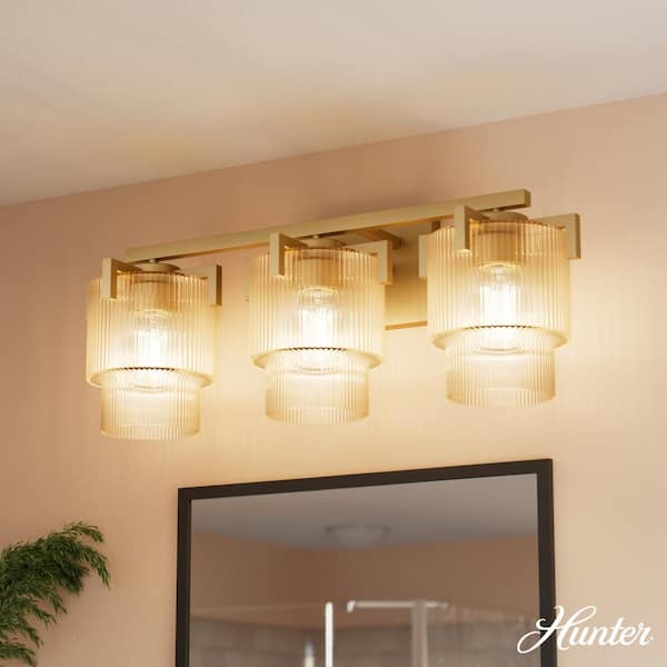 Ontario 24.25 in. 3-Light Luxe Gold Vanity Light with Amber Ribbed Glass Shades