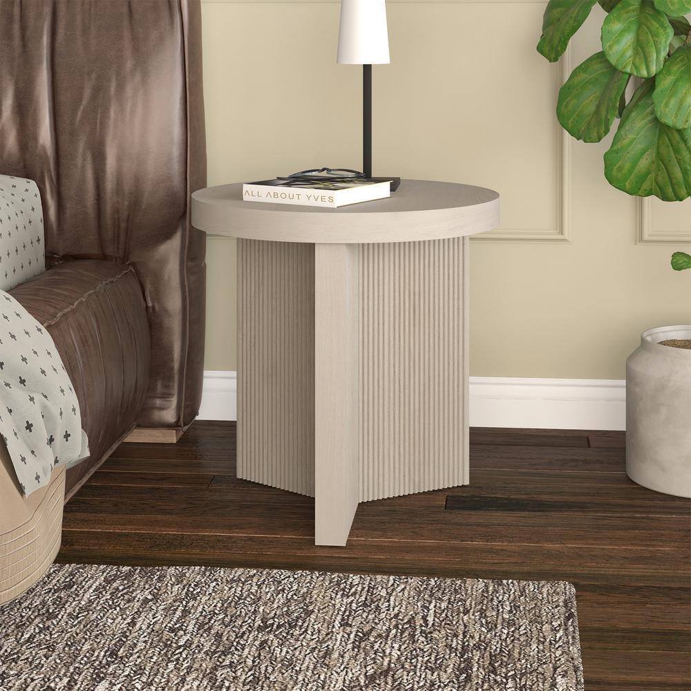 Holm round white end table in a living room setting.