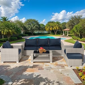 7-Piece Grey Wicker Outdoor Sectional, Rattan Outdoor Patio Set with Dark Blue Cushions, Ottoman and Coffee Table