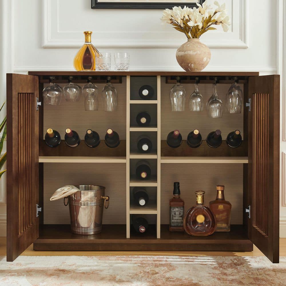 Fully open walnut brown wine cabinet with bottles, glasses, and an ice bucket.