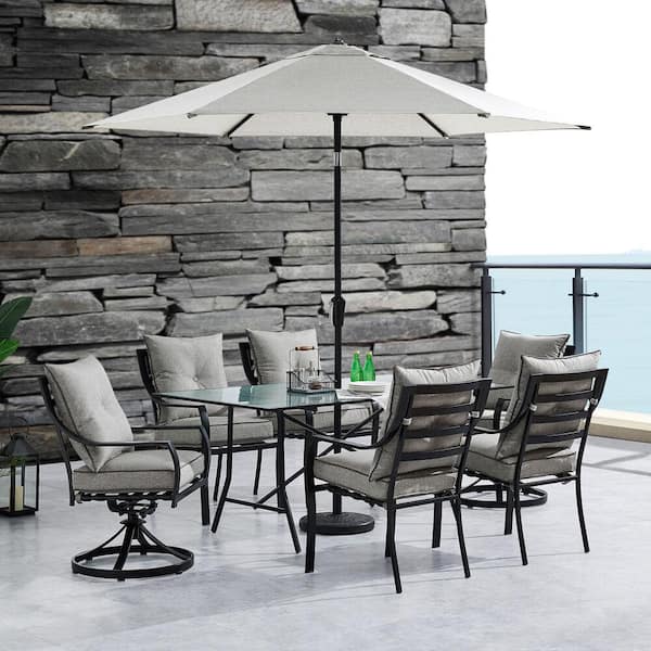 Hanover Lavallette 7-Piece Steel Outdoor Dining Set with Silver Linings Cushions, Chairs, Swivel Rockers, Table, Umbrella/Base