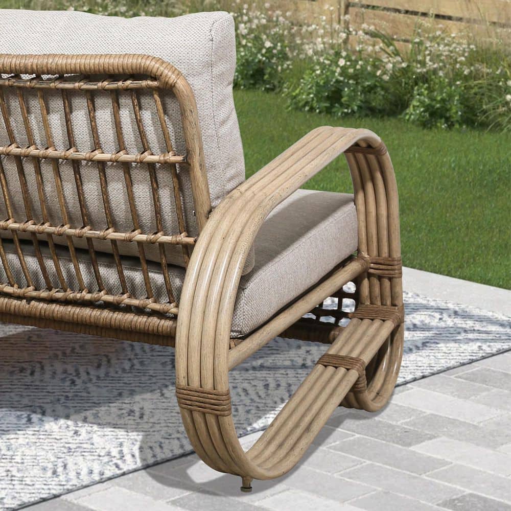Side view of the curved aluminum frame and beige cushion of a patio chair.