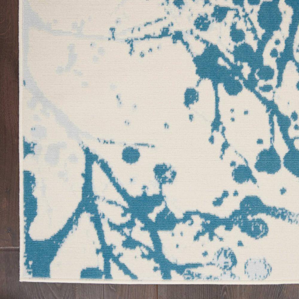 Ivory and Blue Abstract Synthetic 4' x 6' Easy-Care Area Rug