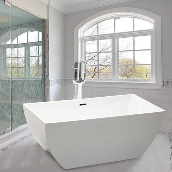 A large luxurious bathroom with a stand alone tub, white vanity