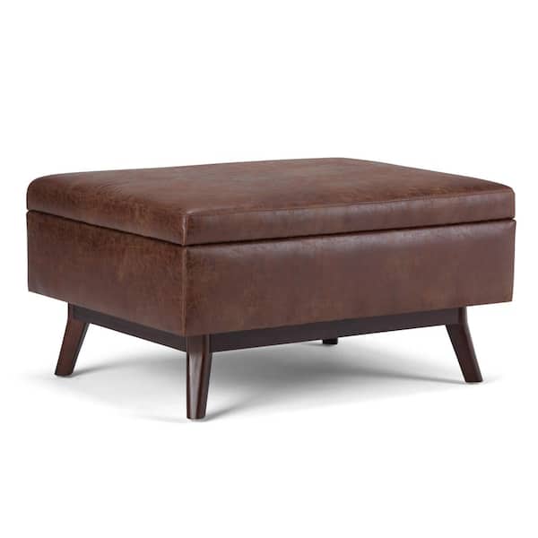 Simpli Home Owen 34 in. Faux Leather Wide Coffee Table Storage Ottoman in Distressed Saddle Brown