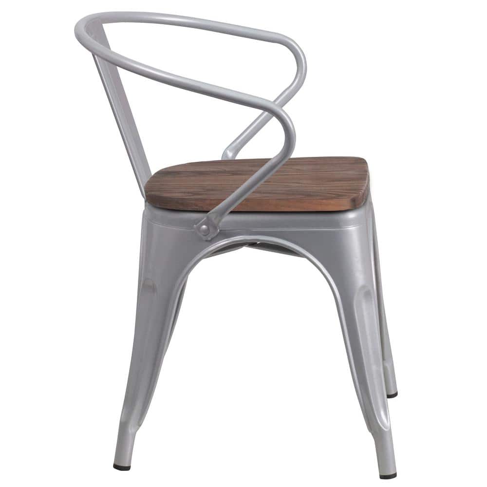 Rear three-quarter view of a silver metal chair with a wooden seat.