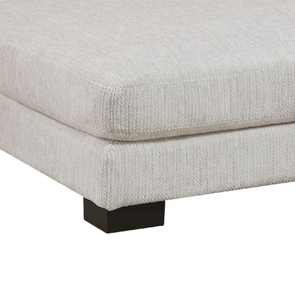 Close-up detail of the ottoman's upholstered top and base.