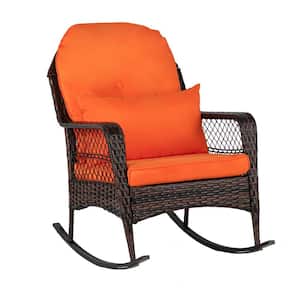 Brown Wicker Outdoor Rocking Chair with Orange Cushion and Pillow