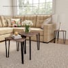 Nesting end tables in a living room with a window and sofa.