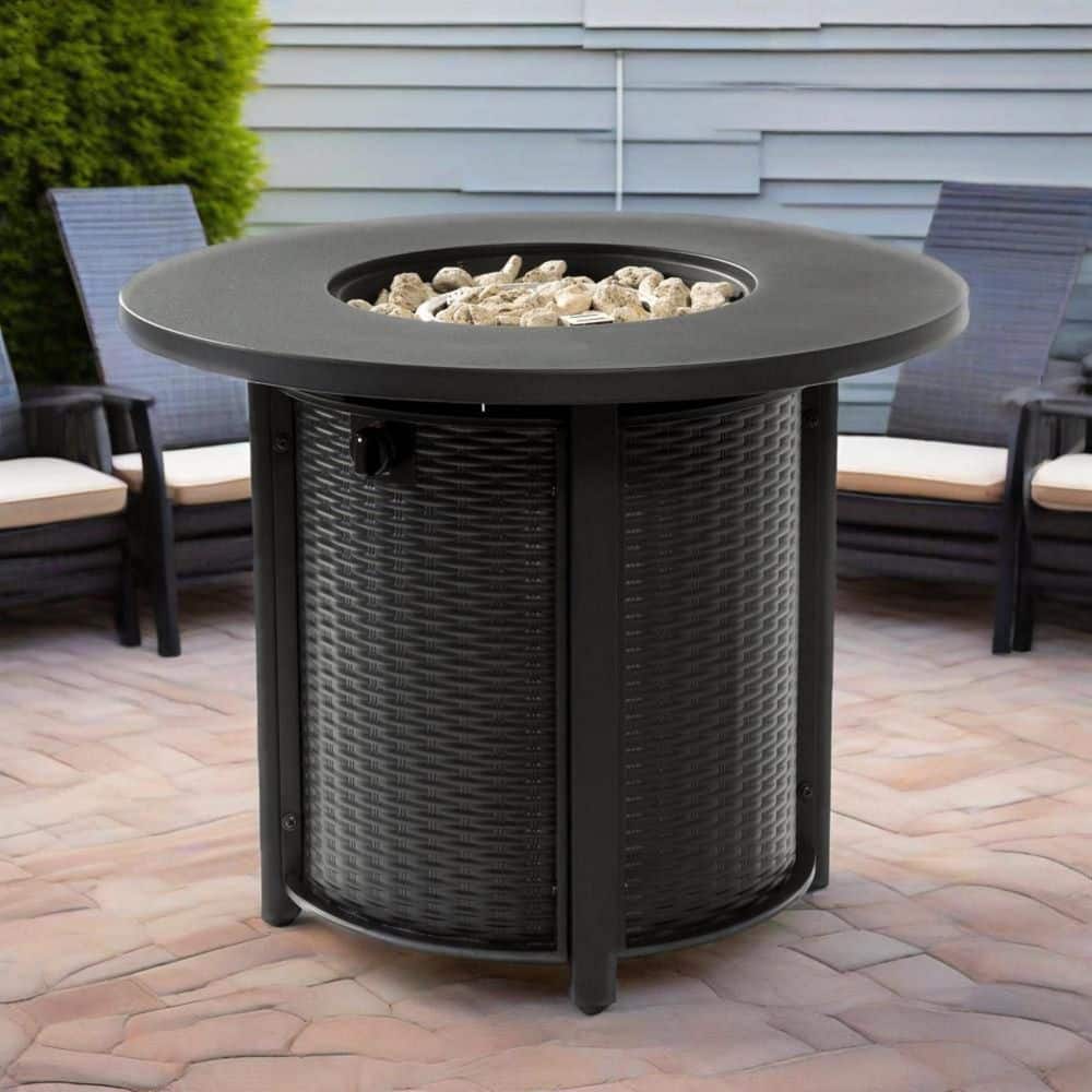 Black round outdoor fire pit table on a brick patio