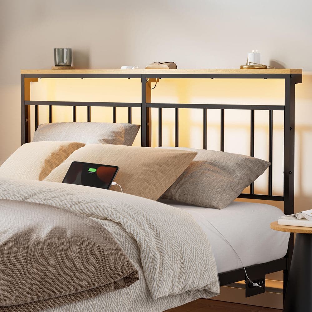 Close-up of the black platform bed headboard with integrated LED lighting and charging station.