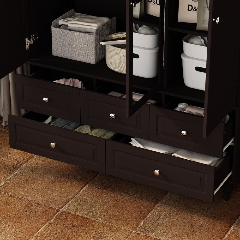 Close-up of the open drawers and lower shelves of a black wardrobe.