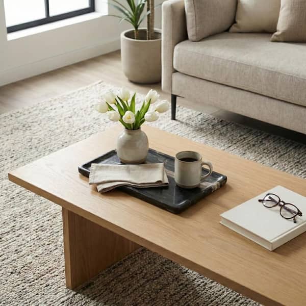 A styled coffee table tray with a deliberately limited number of objects
