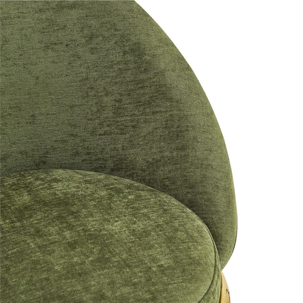 Close-up of the green velvet upholstery on the backrest of a bar stool.