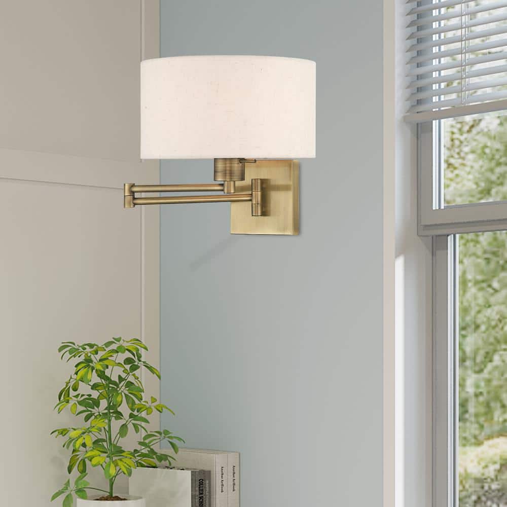Antique Brass Swing Arm Wall Lamp with Oatmeal Shade