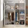 Open wardrobe interior with clothes and storage.