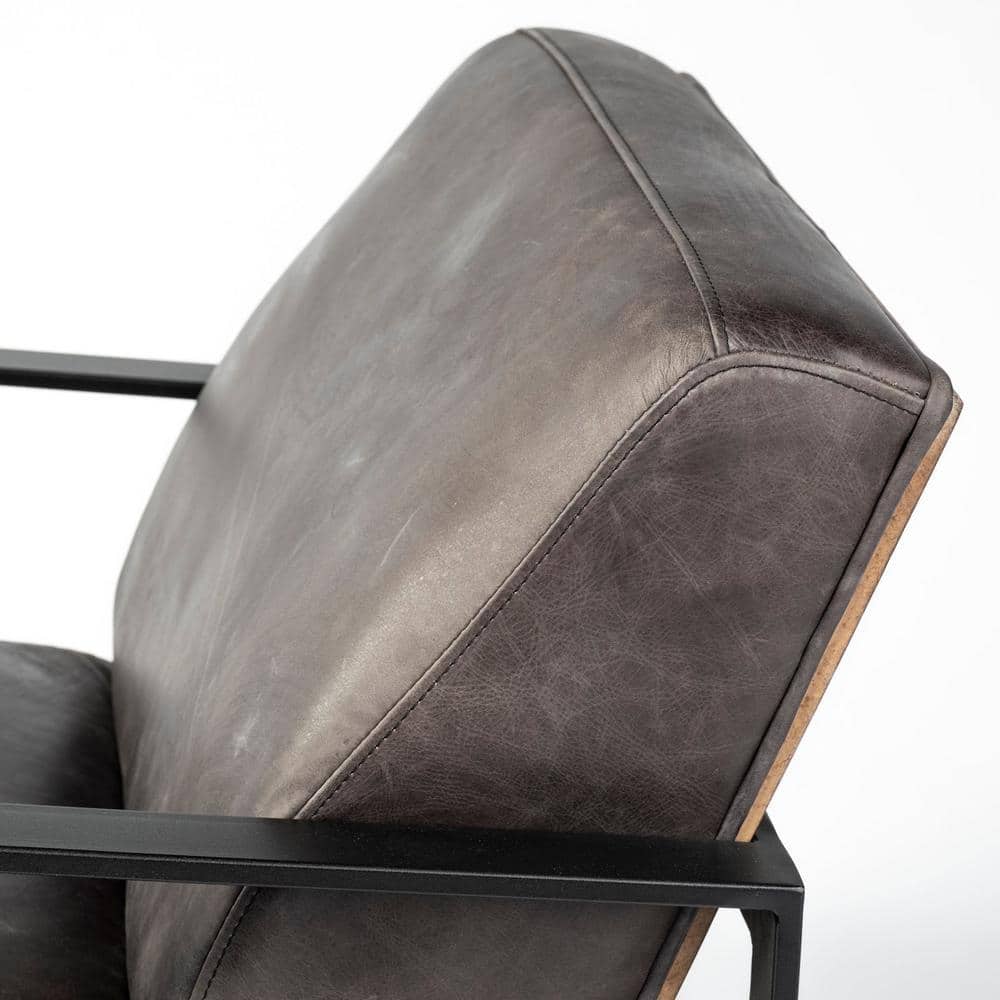 Side view of the black leather backrest of the accent chair.