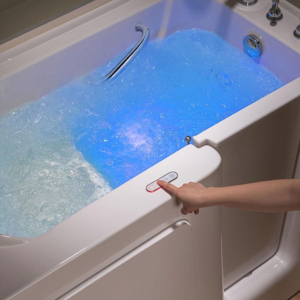 A stunning blue bathroom with a freestanding bathtub, walk-in