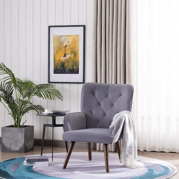 A charcoal gray striped lumbar pillow sits atop a wood and wicker accent  chair positioned at the corner of a white and gray…