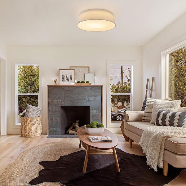 White flush-mount ceiling light replacing a bulky fixture