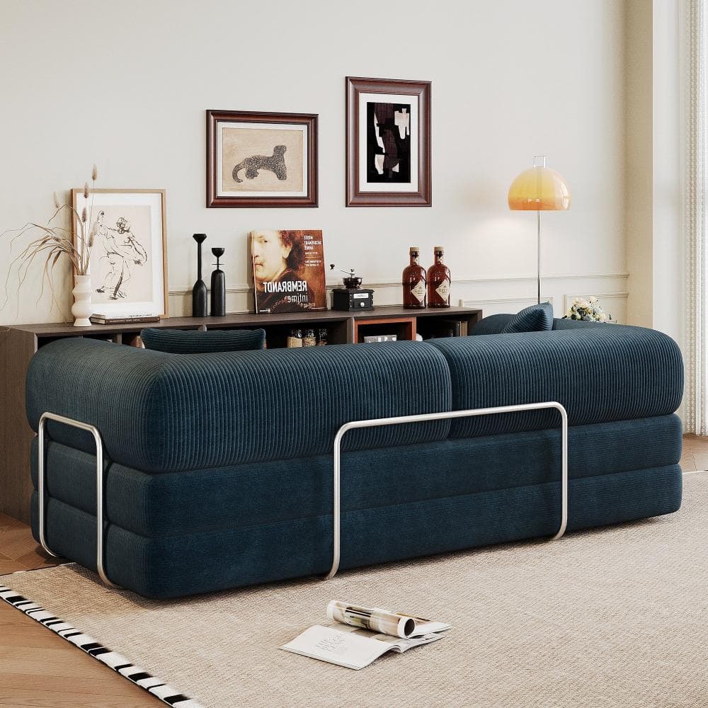 Blue corduroy sectional sofa bed in a styled living room.
