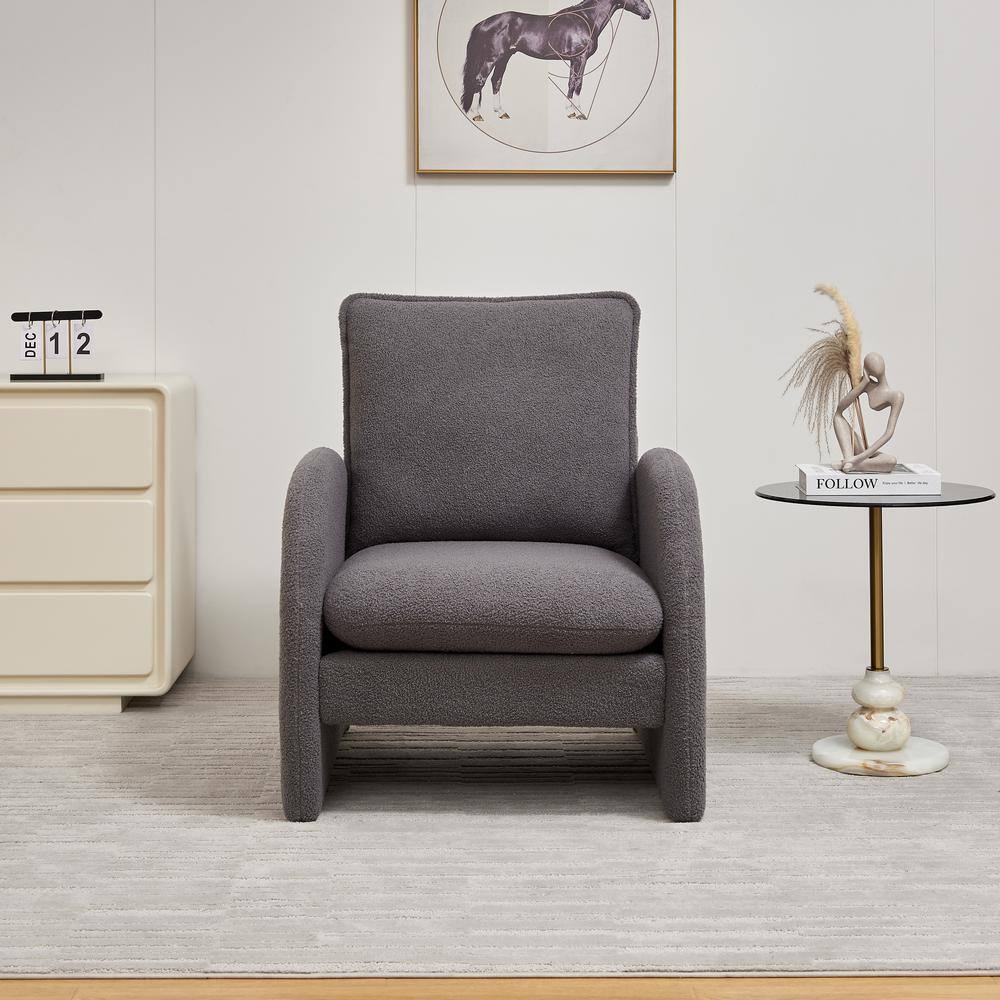 Gray armchair with side table in a room.