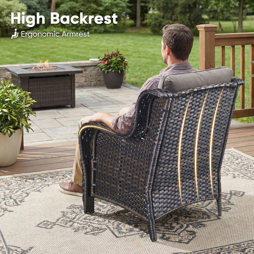 A man sitting in a brown wicker patio chair facing away from the camera.