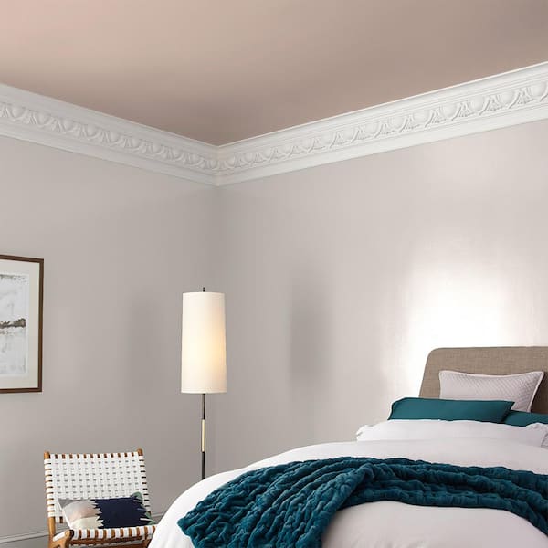 A beautiful pink-beige paint colour is shown on a wall in a bedroom.