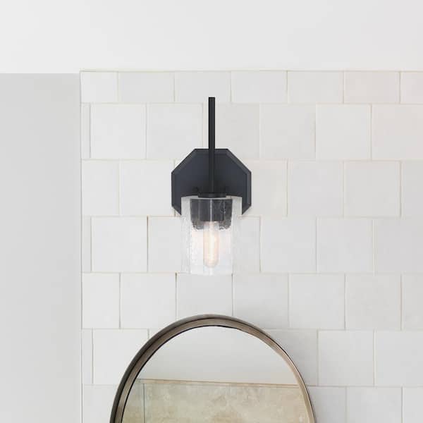 Designers Fountain Haven 7 in. 1-Light Matte Black Classic Wall Sconce with Clear Rippled Glass Shade for Bathrooms