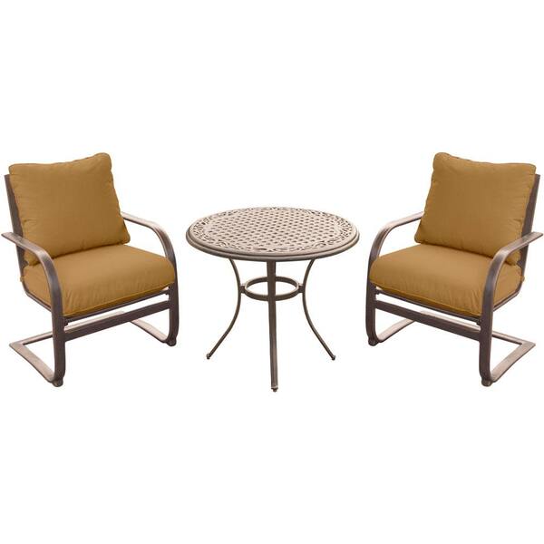 Hanover 3-Piece Outdoor Bistro Set with Aluminum Spring Chairs and Round Cast-Top Table with Desert Sunset Cushions
